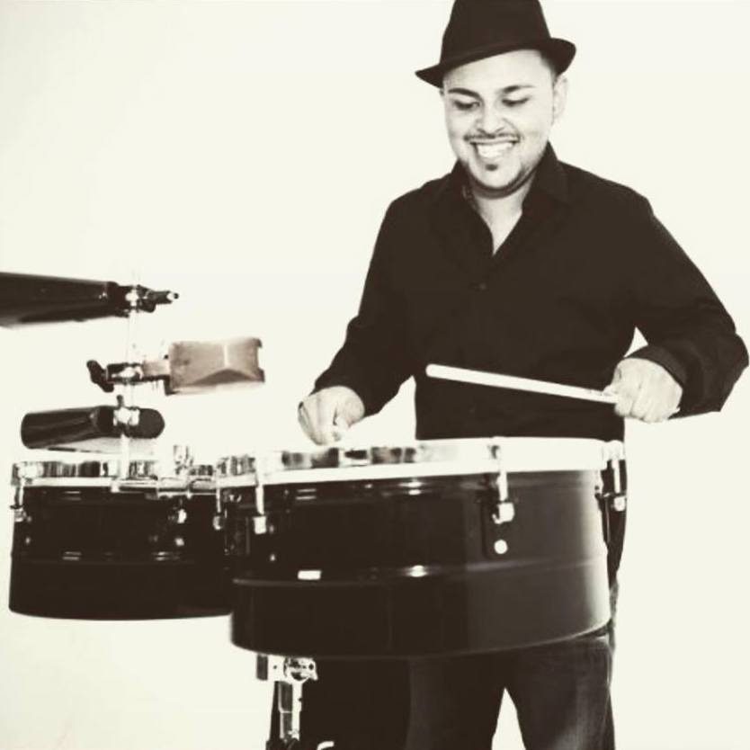 Man playing drums with a smile.