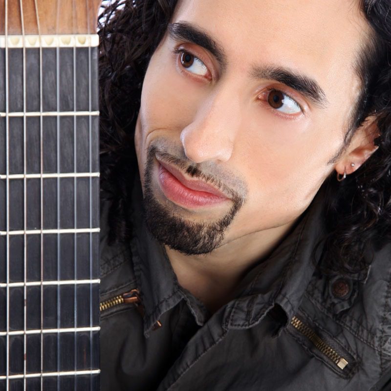 Man looking at guitar, close-up portrait.