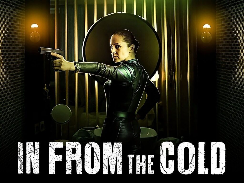 Woman in leather suit pointing gun forward.