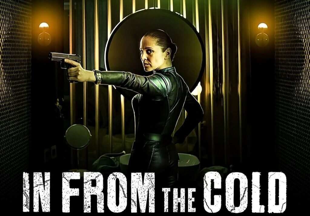 Woman in leather suit pointing gun forward.